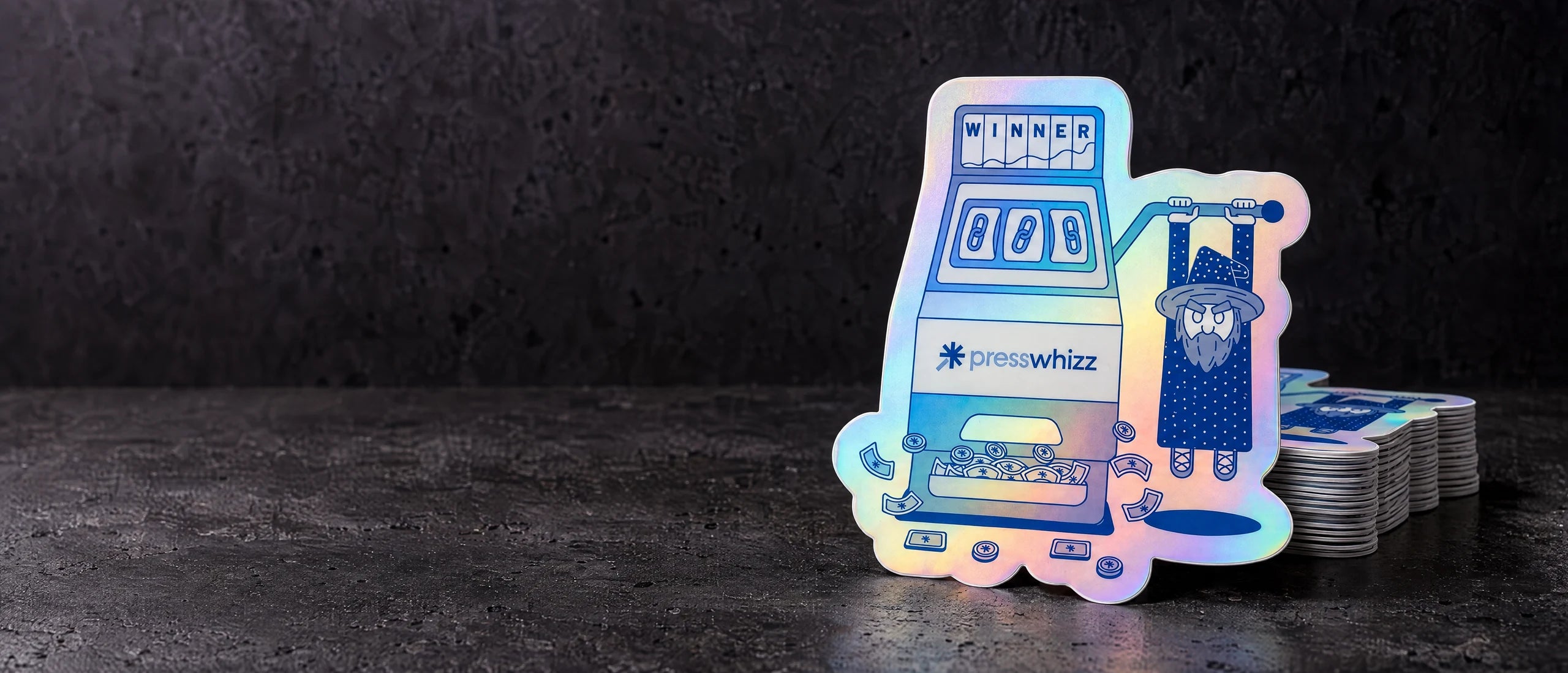 Holographic die cut stickers, photographed on a dark studio surface