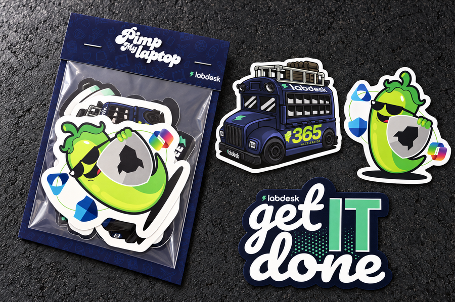 Labdesk Premium sticker pack beside three individual die cut sticker design examples on a charcoal studio surface.