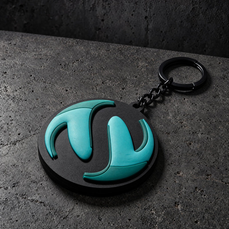 custom 3d domed soft pvc keyrings on a charcoal studio surface — Projectprint