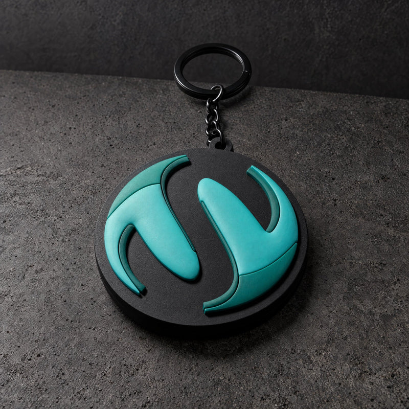 teal sculpted pvc full keyring on a charcoal studio surface — Projectprint