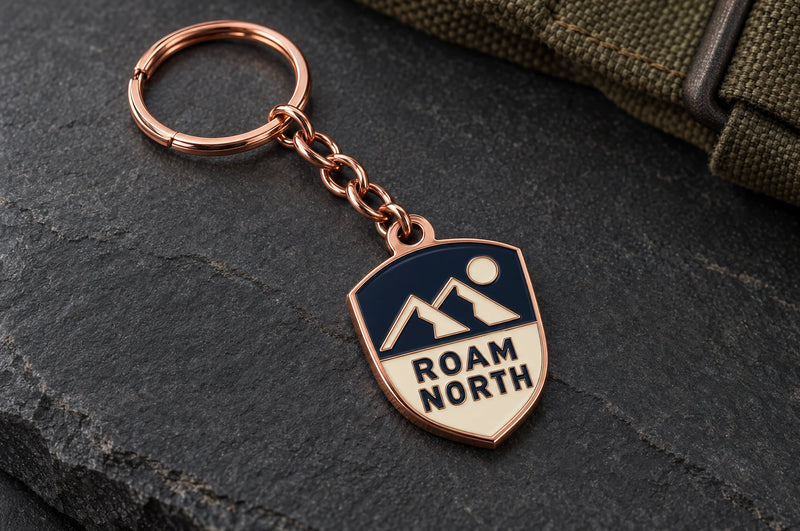 Roam North custom metal enamel keyring design in shiny copper, with matching chain and split ring.