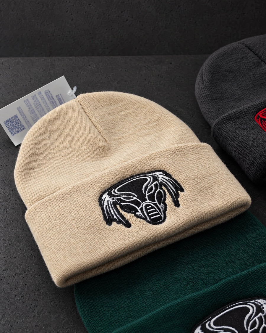 beige embroidered emblem on a charcoal studio surface — Projectprint