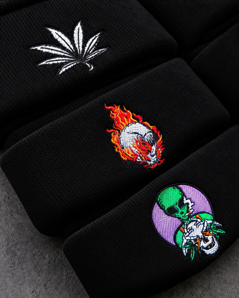 leaf flaming skull alien embroidery detail on a charcoal studio surface — Projectprint