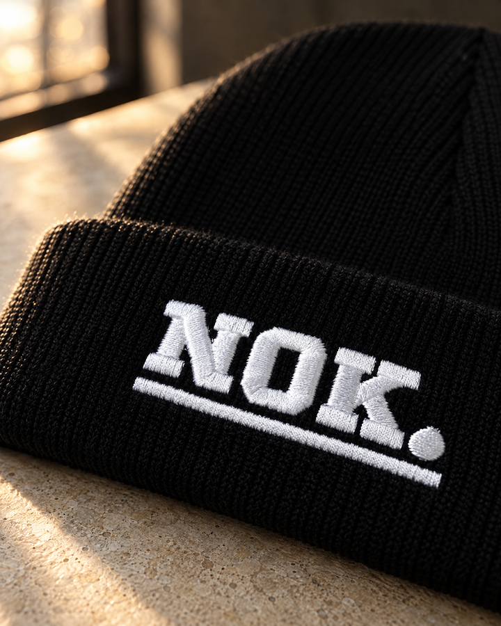 NOK. custom black ribbed cuffed beanie with white embroidered lettering — Project Print customer work, view 2