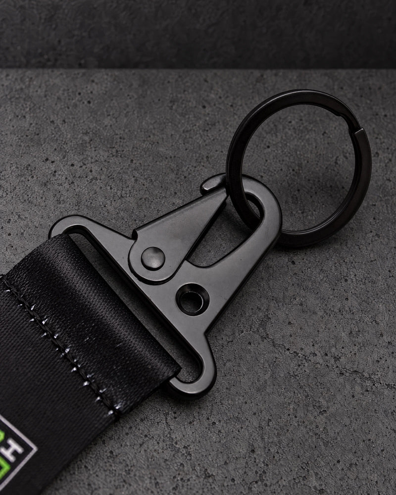 black trigger clasp detail on a charcoal studio surface — Projectprint