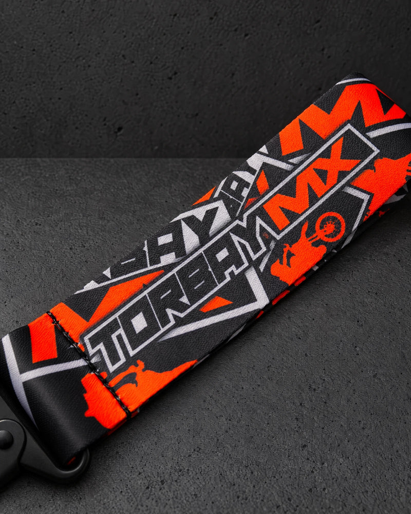 torbaymx orange ribbon print detail on a charcoal studio surface — Projectprint