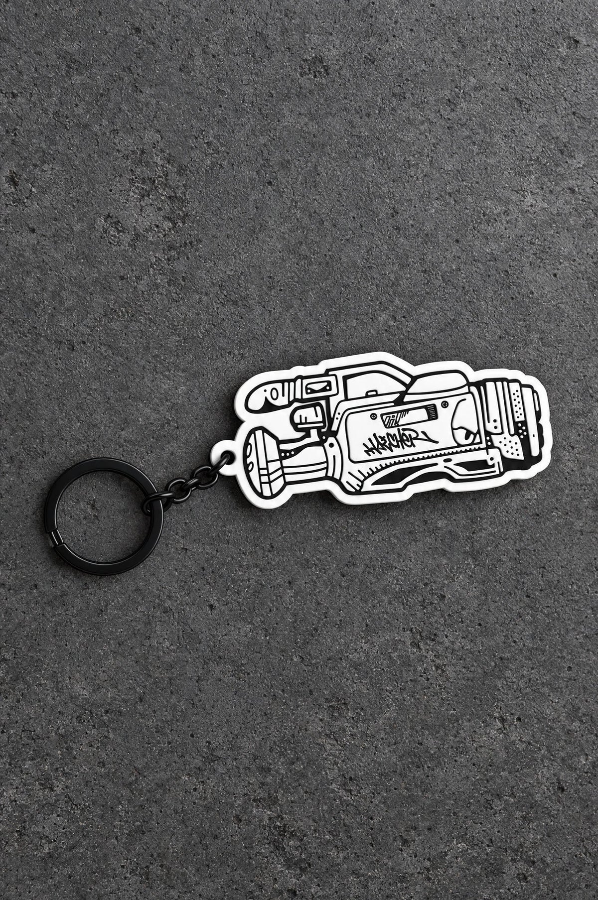 Projectprint custom soft PVC keyring — heat gun, charcoal studio product photograph