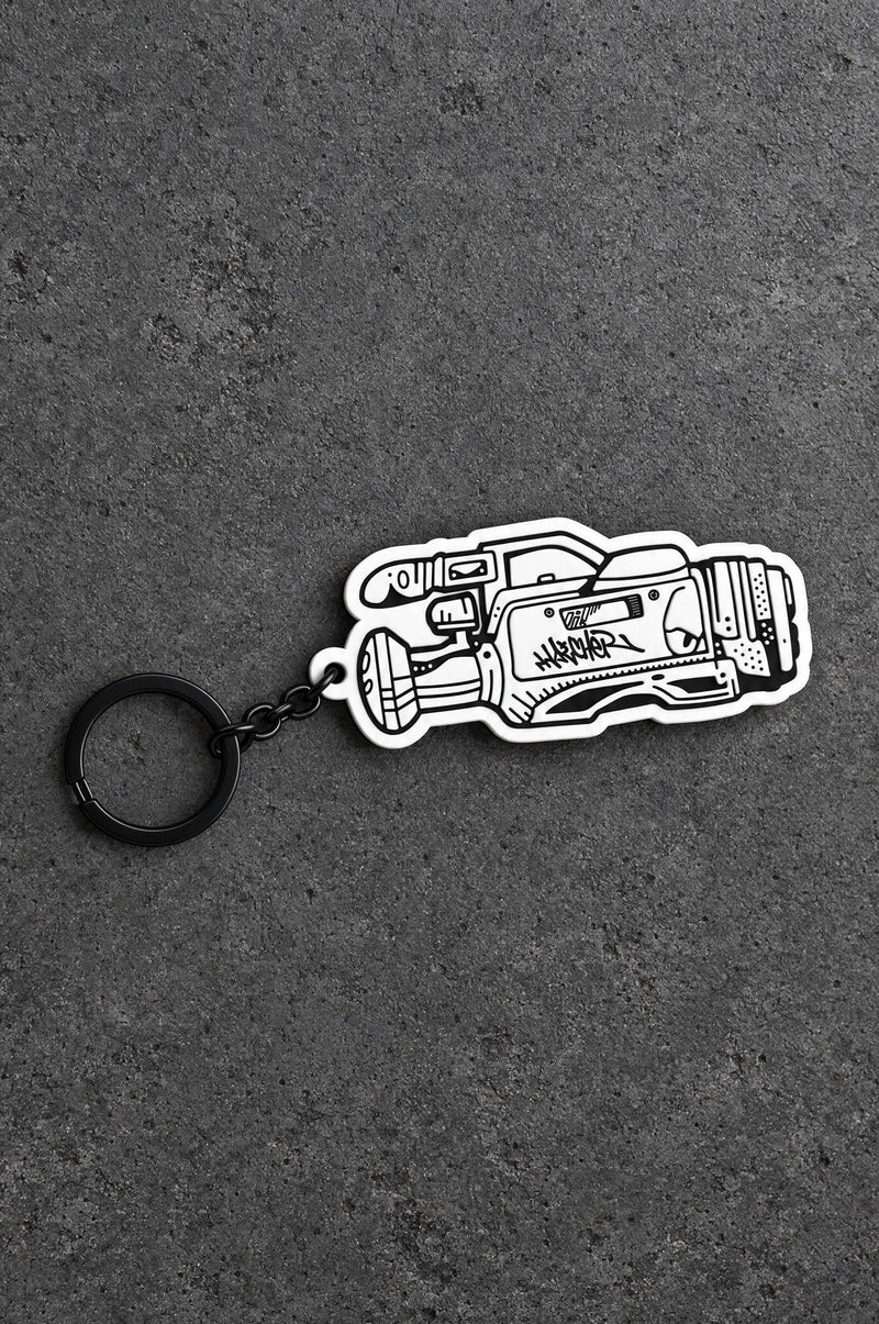 Projectprint custom soft PVC keyring — heat gun, charcoal studio product photograph