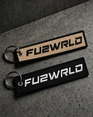 embroidered keyrings on a charcoal studio surface — Projectprint