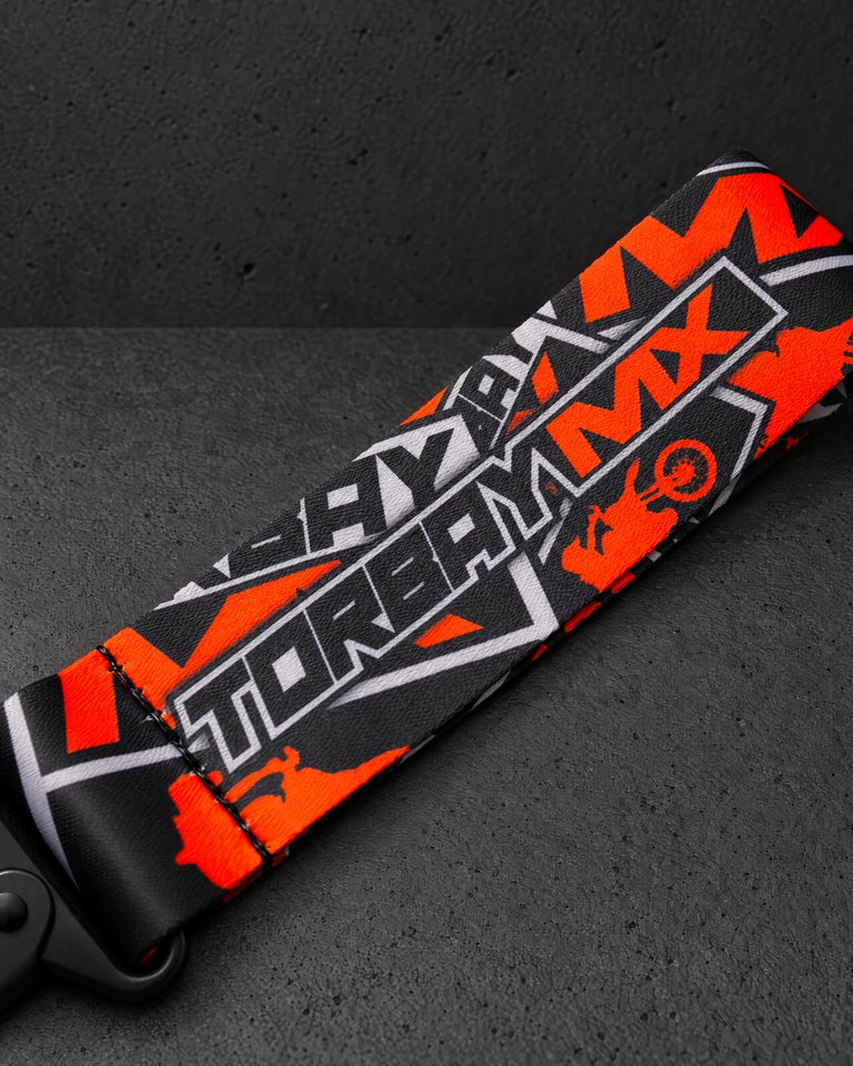 torbaymx orange ribbon print detail on a charcoal studio surface — Projectprint