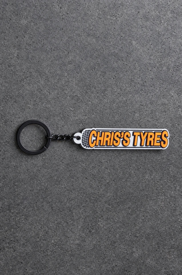 Projectprint custom soft PVC keyring — chriss tyres, charcoal studio product photograph