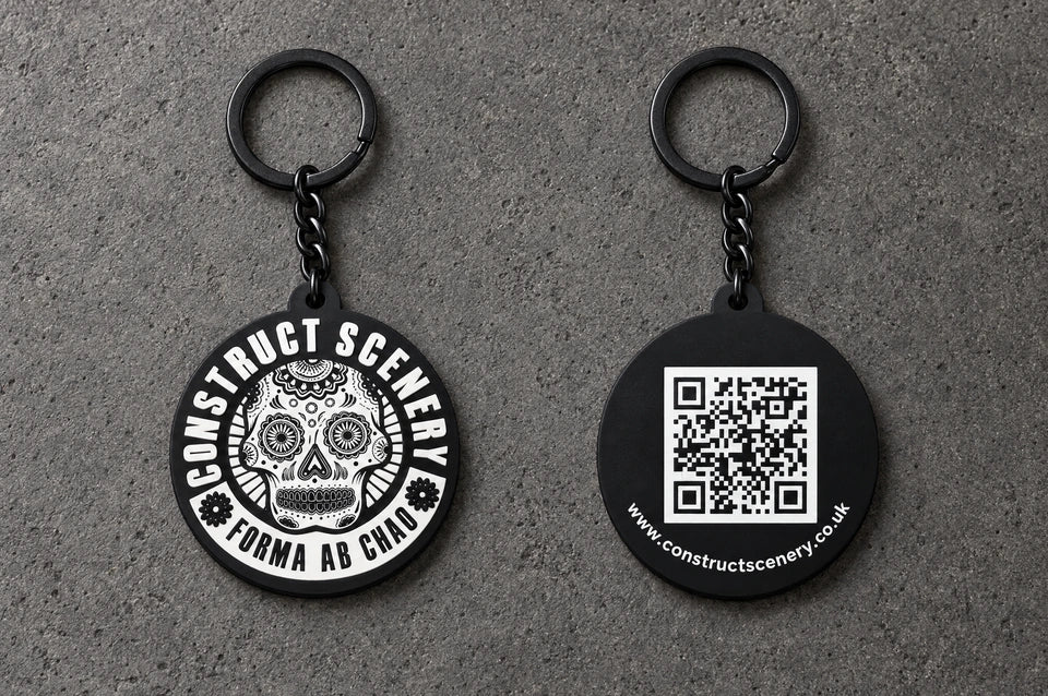 Projectprint custom soft PVC keyring — construct scenery front back, charcoal studio product photograph