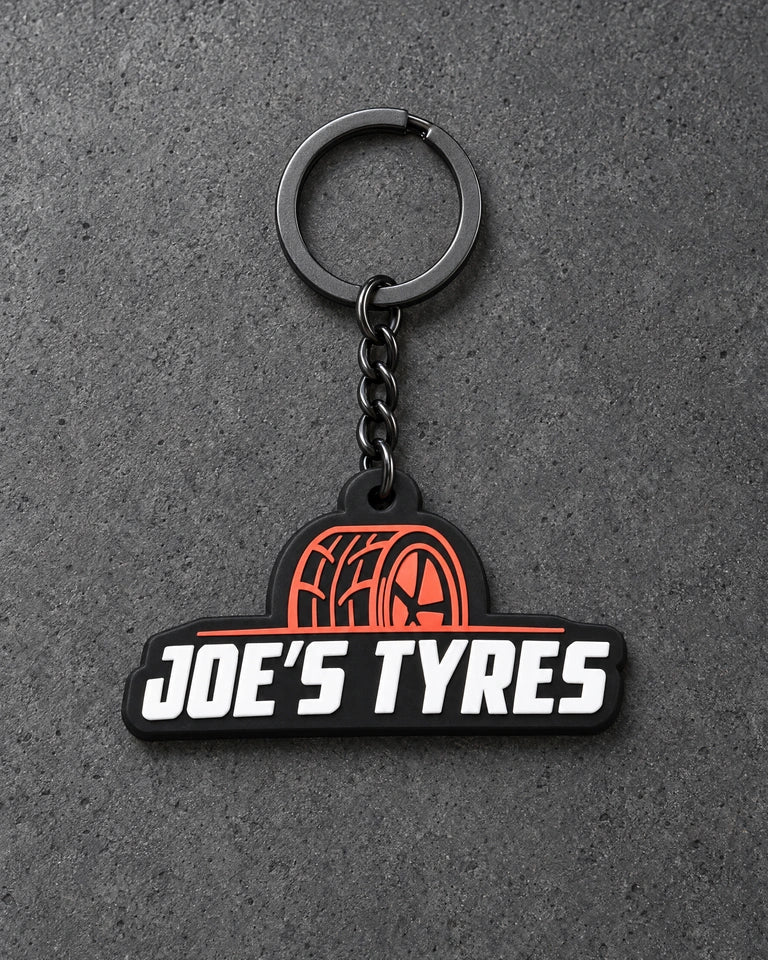 Projectprint custom soft PVC keyring — joes tyres, charcoal studio product photograph