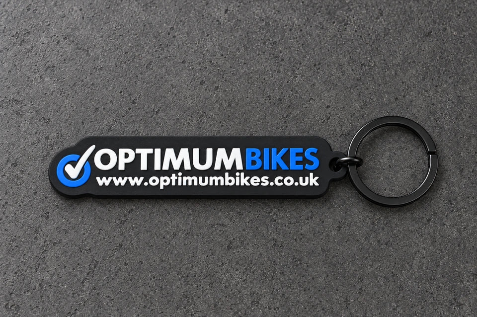 Projectprint custom soft PVC keyring — optimum bikes, charcoal studio product photograph